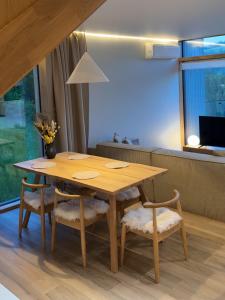 a wooden table and chairs in a living room at Vershe in Verkhovyna