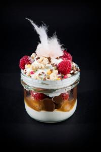 a small jar of dessert with fruit and nuts at Holiday Inn Brighton Seafront by IHG in Brighton & Hove