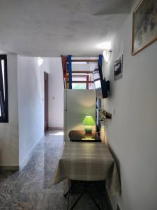 a room with a bunk bed and a green lamp at Egidio Gigi Bellich holiday apartments family houses in Rabac