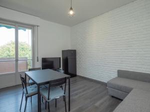 a living room with a table and a couch at I-Host Apartment - Omero 17 in Milan