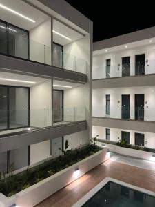 an apartment building with a swimming pool at night at Diamond 3 in Kallithea Halkidikis