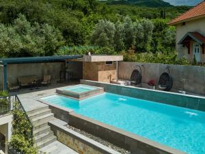a swimming pool in the middle of a backyard at Villa Oaza with Outdoor Pool in Kotor
