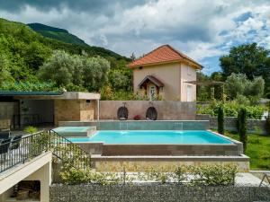 a swimming pool in a backyard with a house at Villa Oaza with Outdoor Pool in Kotor