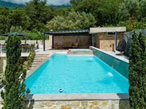a swimming pool with blue water in a backyard at Villa Oaza with Outdoor Pool in Kotor