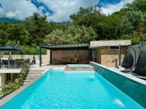 a swimming pool with a patio and a backyard with a house at Villa Oaza with Outdoor Pool in Kotor +51 photos