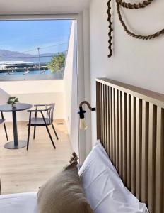 a bedroom with a balcony with a view of the ocean at A caseta de Sil in Lira
