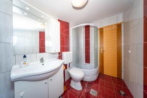 a bathroom with a white sink and a toilet at Seaview family apartments Dubrava in Pag +44 photos