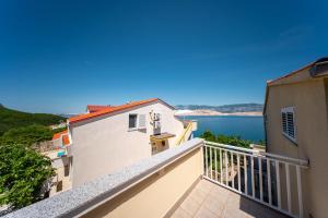 a balcony with a view of the water at Seaview family apartments Dubrava in Pag