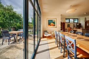 a dining room with a table and chairs at Luxury Glenardle Lodge with Hot Tub and Forest Views in Bridge of Cally