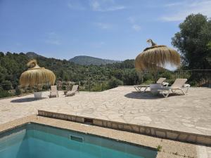 a patio with two chairs and a swimming pool at Agroturismo Finca Can Sec in Alaró