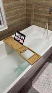 a tablet sitting on top of a bath tub at Barney's Pointe Beach House, Batangas City in Batangas City