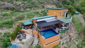 an aerial view of a house with a swimming pool at Barney's Pointe Beach House, Batangas City in Batangas City