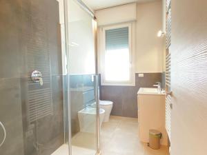 a bathroom with a shower and a toilet and a sink at Suite Emilia 6 in Bologna