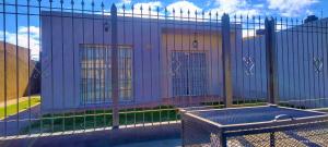 a purple building with four doors on a fence at Casa ciudad de San Luis in San Luis