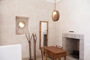 a living room with a mirror and a table at Masseria Borgo Sentinella in Torre dell'Orso