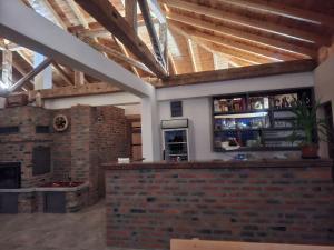 a large room with a bar with a brick wall at Seosko domaćinstvo Kastratović in Berane +31 photos