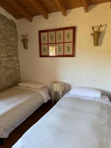 A bed or beds in a room at Masía La Costereta