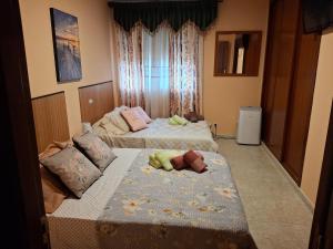 a bedroom with two beds with babies laying on them at Casa Rural & Parrillada Miguel in Lousame