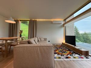 a living room with a couch and a tv and a table at Vershe in Verkhovyna +23 photos