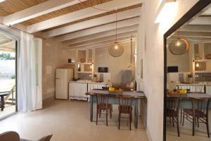 a kitchen and dining room with a table and chairs at Masseria Borgo Sentinella in Torre dell'Orso