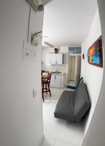 a view of a living room and kitchen from a doorway at Playa Los Cocos Apat 2 y 3 in Santa Marta