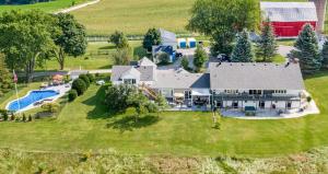 an aerial view of a large house with a pool at Mountain Ash Country Manor and Spa in Creemore +68 photos