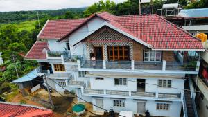 an overhead view of a house with a red roof at KV Guest House in Mudigere
