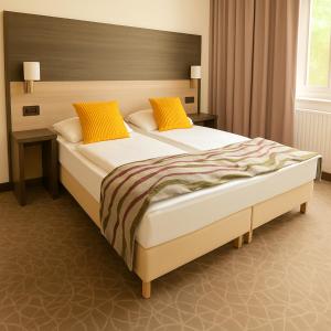 A bed or beds in a room at Arion Cityhotel Vienna