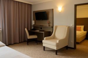 A bed or beds in a room at Arion Cityhotel Vienna