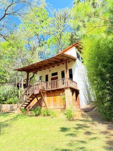 a house with a deck on the side of it at Nostra Natura Chalets in Mazamitla