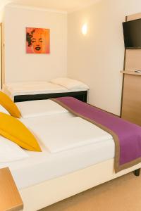 A bed or beds in a room at Arion Cityhotel Vienna