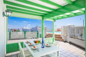 a table on a balcony with a view of the city at Casa Sussa in Tías
