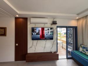 a living room with a flat screen tv on a wall at Playa 7 in Martil