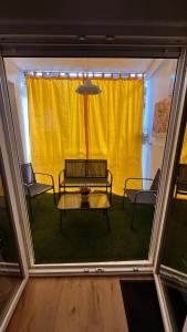 a room with a table and chairs and a yellow curtain at Casa Palomar in Zamora