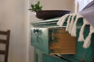 a green chest with a bowl on top of it at Masseria Borgo Sentinella in Torre dell'Orso