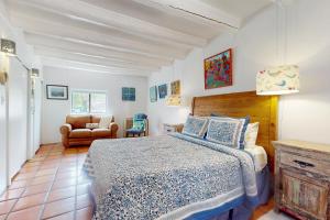 a bedroom with a bed and a chair at The Bird House in Taos