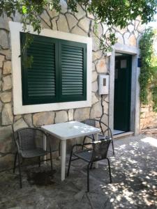 a table and two chairs in front of a building at Old Town Primošten in Primošten