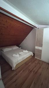 a bedroom with a bed and a wooden floor at Old Town Primošten in Primošten