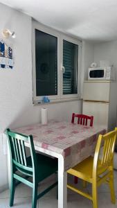 a dining room table with two chairs and a table and a table and chairsktop at Old Town Primošten in Primošten +3 photos