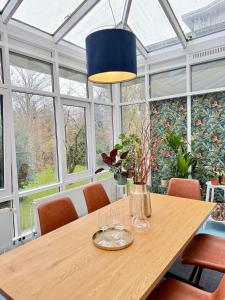 a dining room with a table with wine glasses at Luxury 5BR City Villa - Chic & Spacious - Families in Oldenburg +57 photos