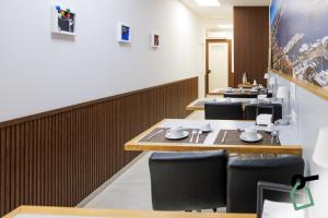 a row of tables and chairs in a restaurant at Botanique Napoli - 4 Design Rooms in Naples
