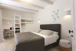 a bedroom with a large bed and a desk at Masseria Borgo Sentinella in Torre dell'Orso