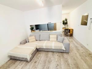 a bedroom with a large bed in a white room at Appart Hotel 23 - Le Cocon Creusois 1 in Guéret