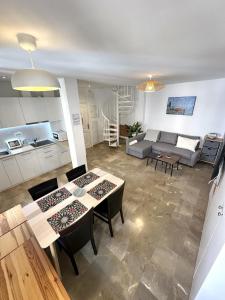 a living room with a couch and a table at Colcha Suites - Duplex Penthouse in Granada