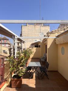a balcony with a table and chairs on a building at Colcha Suites - Duplex Penthouse in Granada +20 photos