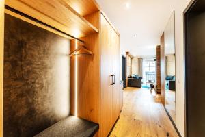 a hallway of a house with a wooden door at Luxury Apartment Murmeltier mit 4-Sterne Hotelanbindung in Oberstaufen