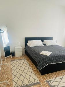 a bedroom with a black bed and a mirror at Baveno Lakeview Escape in Baveno