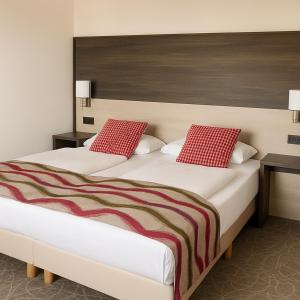 A bed or beds in a room at Arion Cityhotel Vienna