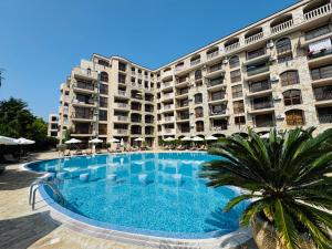 a large apartment building with a large swimming pool at KALIA C9 One Bedroom Apartment in Sunny Beach