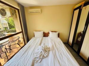 a white bed in a room with a window at KALIA C9 One Bedroom Apartment in Sunny Beach +34 photos